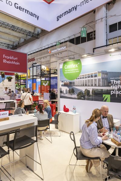 Kundengespräche an Tischen auf dem Messestand des CCB